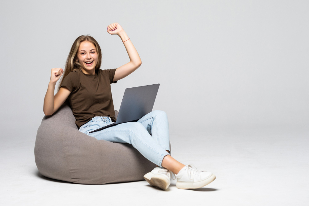 https://seedandspark-static.s3.us-east-2.amazonaws.com/images/User/001/491/707/medium/young-woman-sitting-pufff-with-laptop-with-win-gesture-isolated-white-wall.jpg image